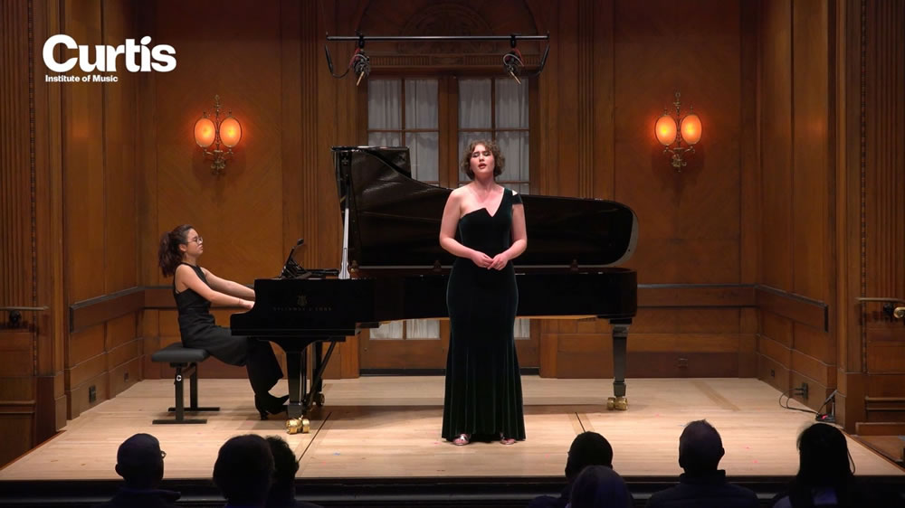 A moment from my performance in Field Concert Hall with my fellow classmate, Jessie Gong, on piano